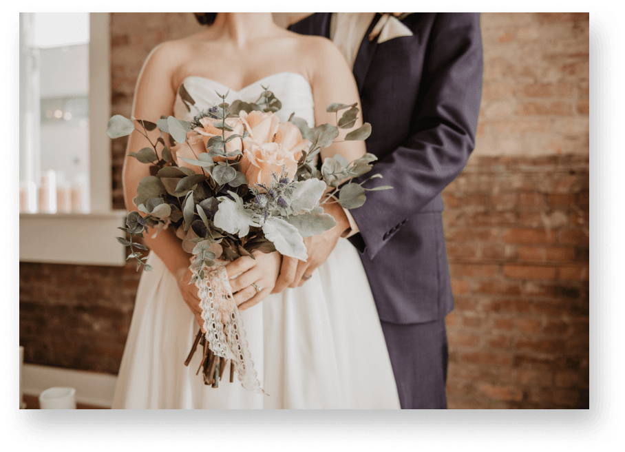 Bride and groom holding a bouquet