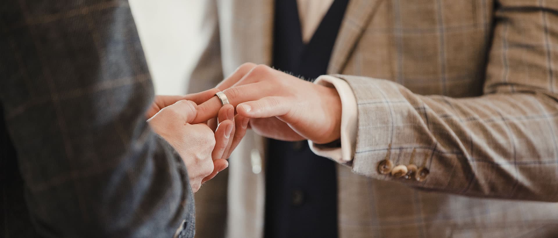 Wedding ring being placed on a finger during ceremony